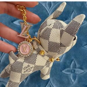 Novelty Cream and Black Small Dog Gold Keychain with two logo charms